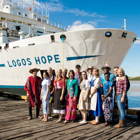 Logos Hope crewmembers pose in their national costumes at the bow.