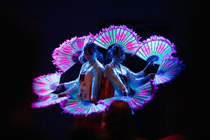 Korean fan dance group performs during an onboard event.