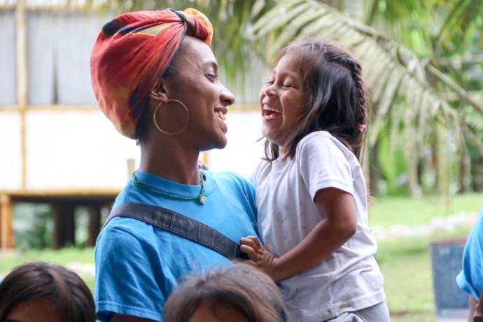 Crewmember laughing with child