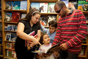 A family visit the book fair on Logos Hope